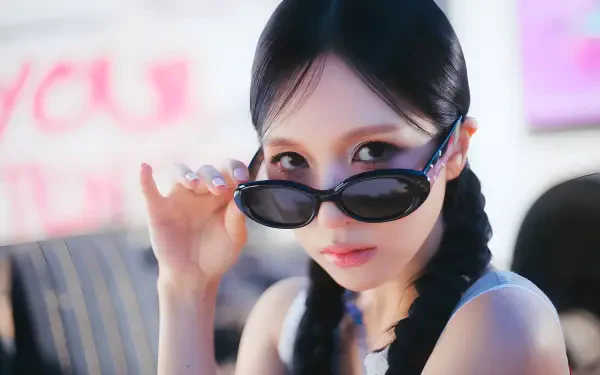 4K desktop wallpaper of a K-pop idol in shades with braided pigtails, evoking Twice's chic aesthetic.