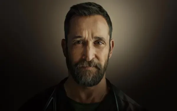 Close-up portrait of a bearded middle-aged man with short hair against a dark vignette, titled The Pitt — 4K Ultra HD PC desktop wallpaper/background.