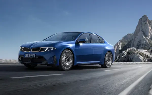 Blue BMW i3 on a mountain road under a clear sky — 2K Quad HD PC desktop wallpaper/background featuring the sleek blue vehicle.