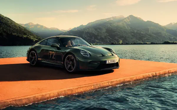 Porsche 911 GT3 parked on a pier beside a mountain lake at sunset — 4K Ultra HD PC desktop wallpaper of a green performance car/vehicle.