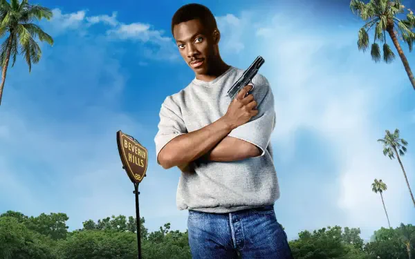 4K Ultra HD PC Desktop Wallpaper and Background: a man in jeans and a gray sweatshirt holds a pistol with arms crossed beneath a bright blue sky, palm trees and a roadside sign.