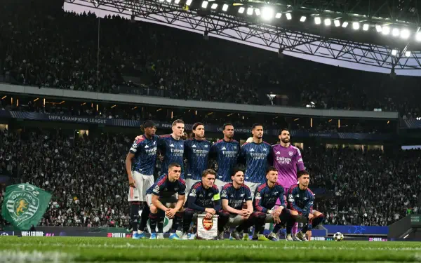 Arsenal F.C. squad lined up on the pitch before a UEFA Champions League match, 4K Ultra HD PC desktop wallpaper and background.