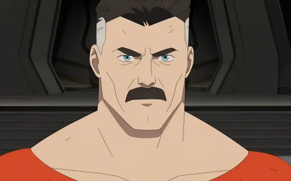 Omni-Man from TV show Invincible, close-up stern expression and mustache against a dark interior — 2K Quad HD PC desktop wallpaper/background.