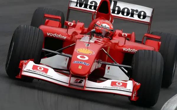 4K Ultra HD PC wallpaper of a red Ferrari F1 car on track, close-up of helmeted F1 driver in classic Marlboro-liveried Ferrari.