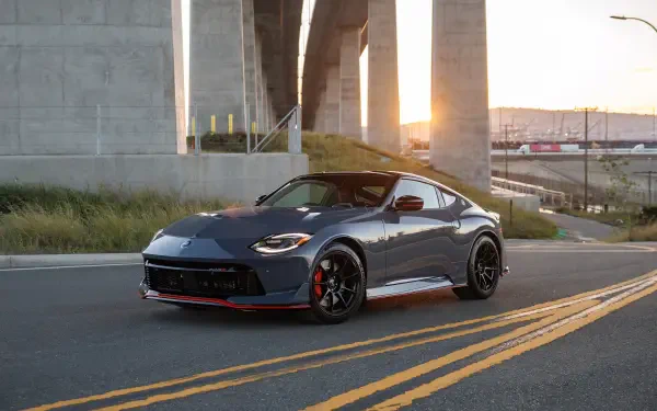 Nissan Z Nismo sports vehicle parked on an urban road beneath a concrete bridge at sunset — 4K Ultra HD PC desktop wallpaper and background.