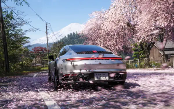 Forza Horizon 6 video game 4K Ultra HD PC wallpaper: rear view of a Porsche driving down a road carpeted in sakura petals beneath blooming cherry trees.