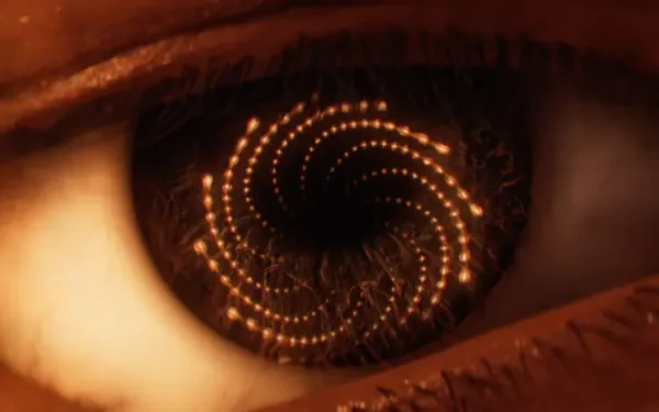 Close-up of an eye with a glowing golden spiral in the pupil; video game Saros 4K Ultra HD PC desktop wallpaper/background.