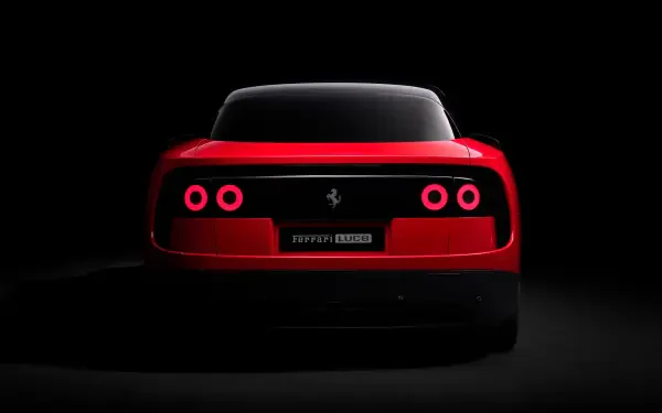 Rear view of a red Ferrari Luce with four glowing round taillights against a dark backdrop — 4K Ultra HD PC desktop wallpaper