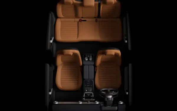 Top-down view of a Ferrari Luce interior with tan leather seats, center console and steering wheel — 4K Ultra HD PC desktop wallpaper and background.