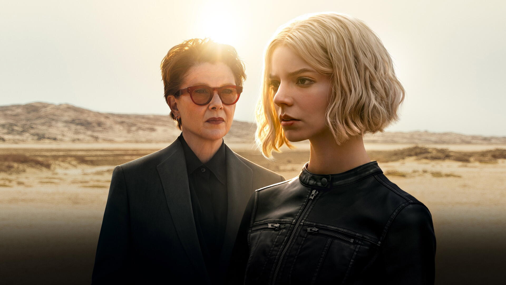 Lucky — 4K Ultra HD PC Desktop Wallpaper and Background: two stoic figures in black jackets stand in a sunlit desert, an older one with sunglasses behind a short blonde woman.