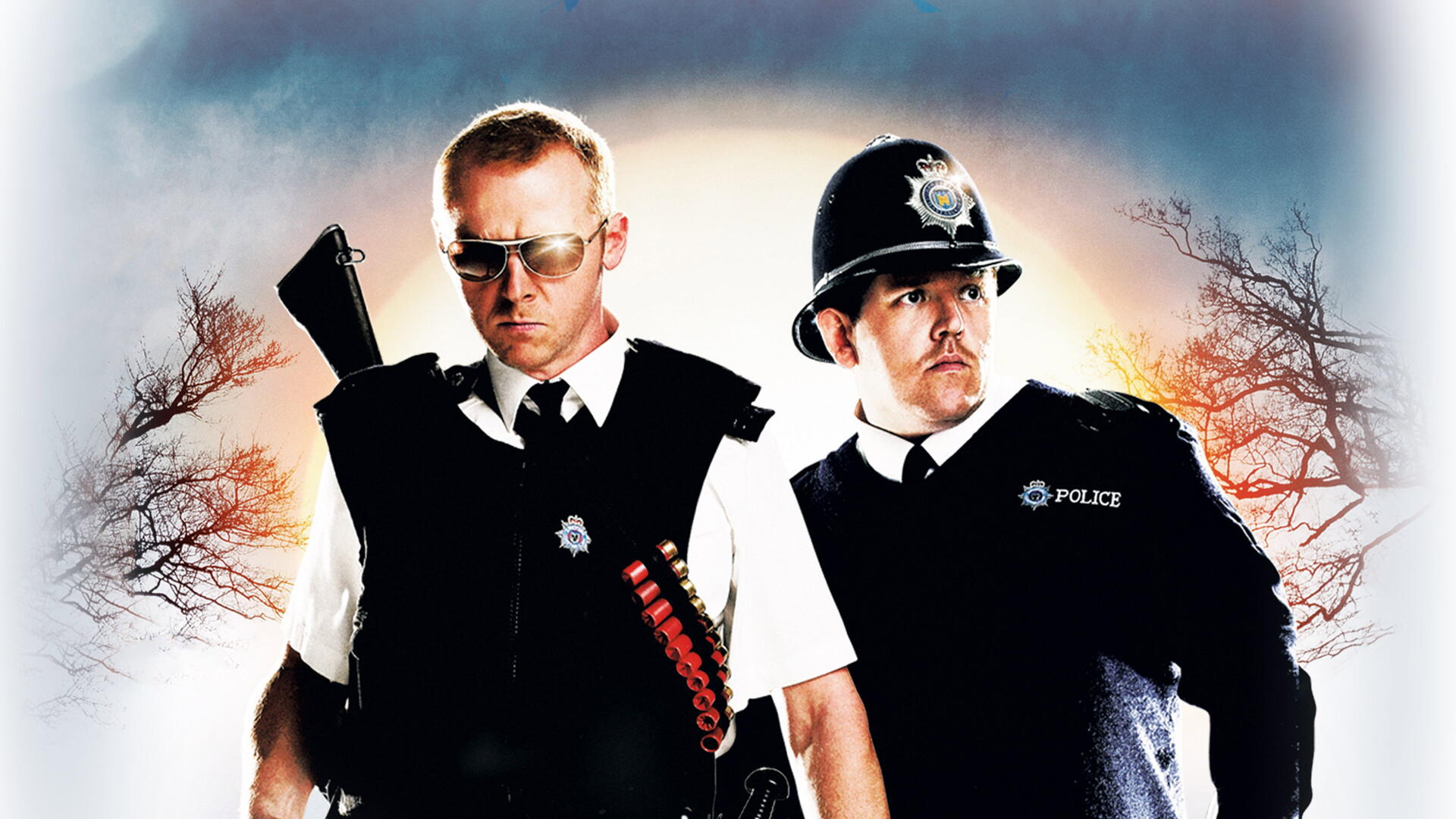 Hot Fuzz 4K Ultra HD PC desktop wallpaper: two stern uniformed police officers—one wearing sunglasses with shotgun-shell bandolier, dramatic sky and silhouetted trees.