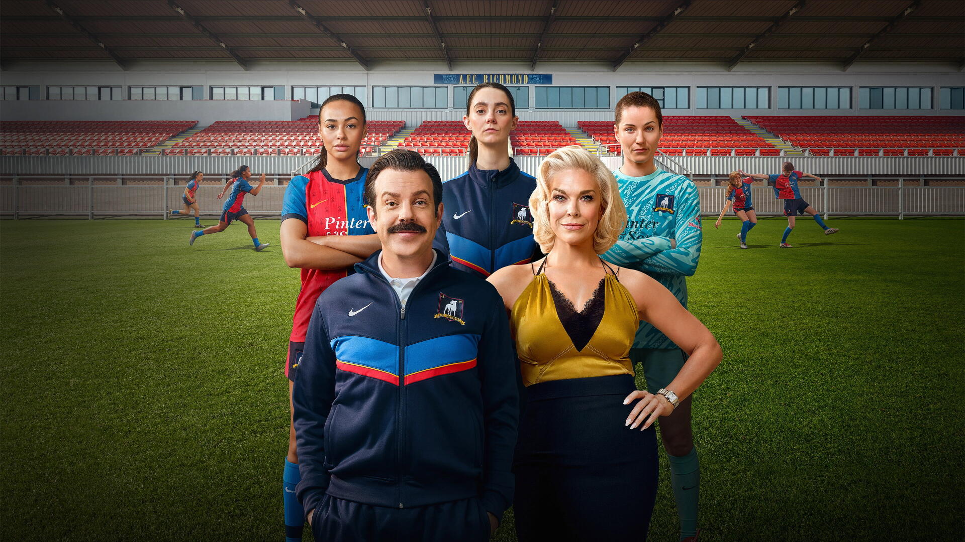 4K Ultra HD PC desktop wallpaper featuring a mustachioed soccer coach with three players on a stadium pitch; image tagged Ted Lasso.