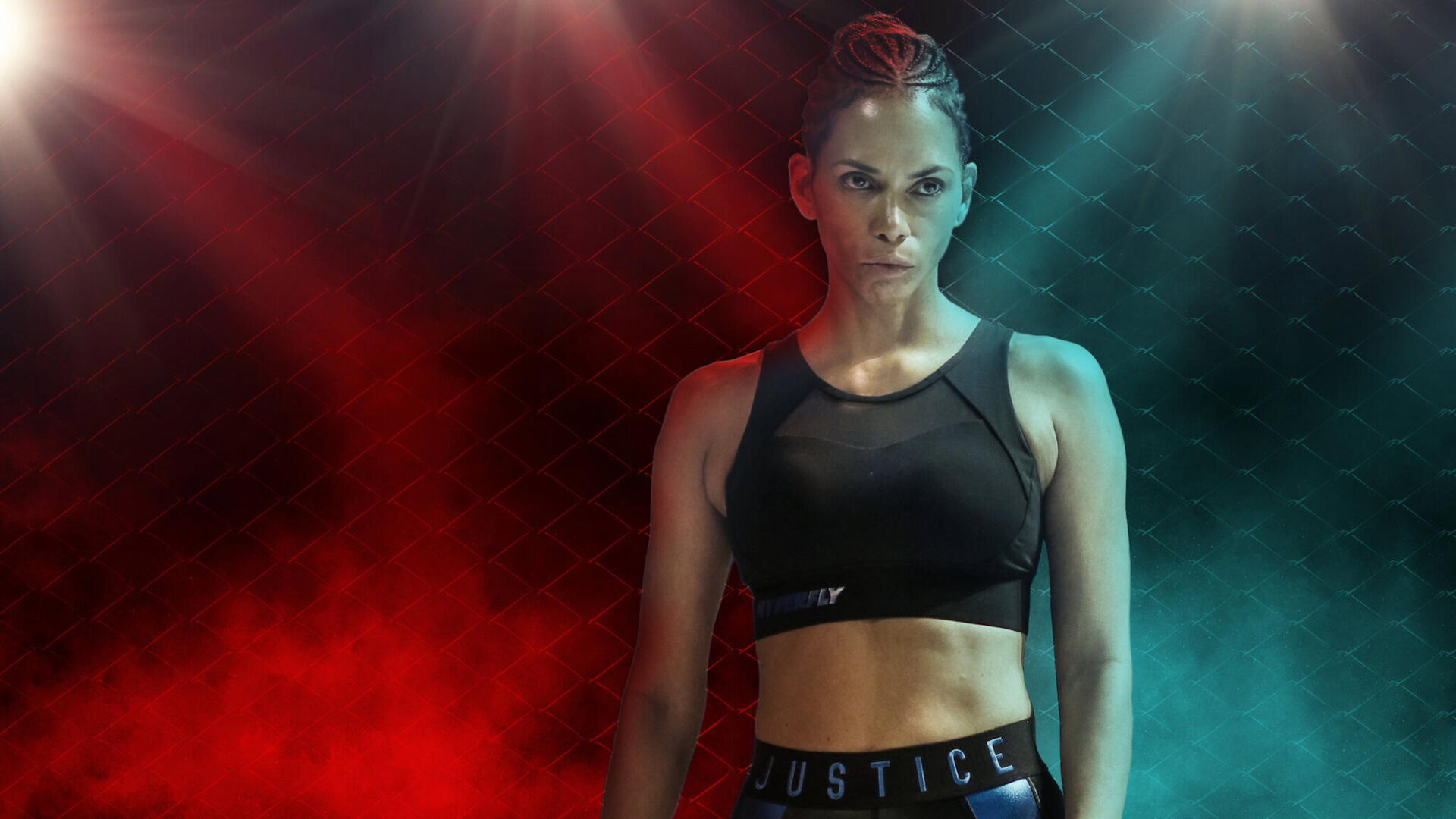 HD PC desktop wallpaper: bruised female athlete in a sports bra and Justice shorts stands under red and teal stage lights, wearing a resolute expression.