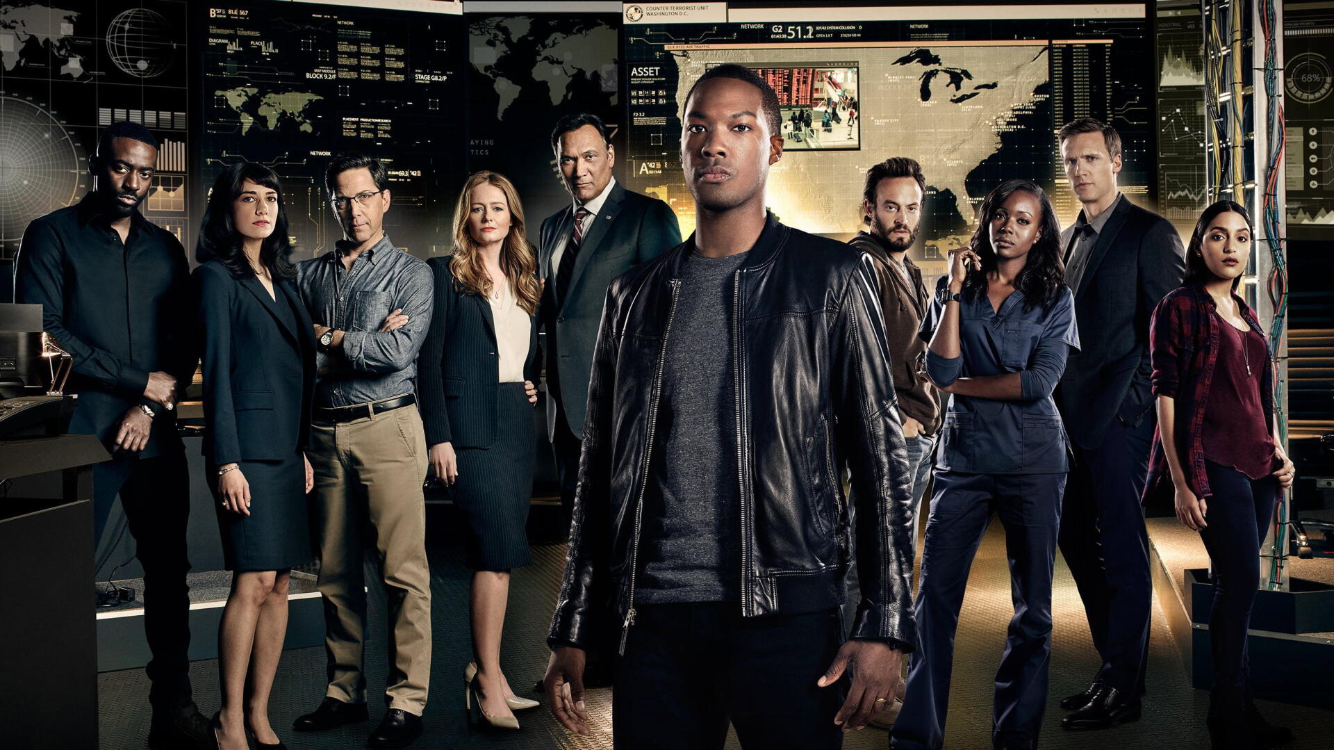 2K Quad HD PC desktop wallpaper for 24: Legacy showing a diverse ensemble of agents in a dim command-center, with a leather-jacketed lead figure standing front and center.