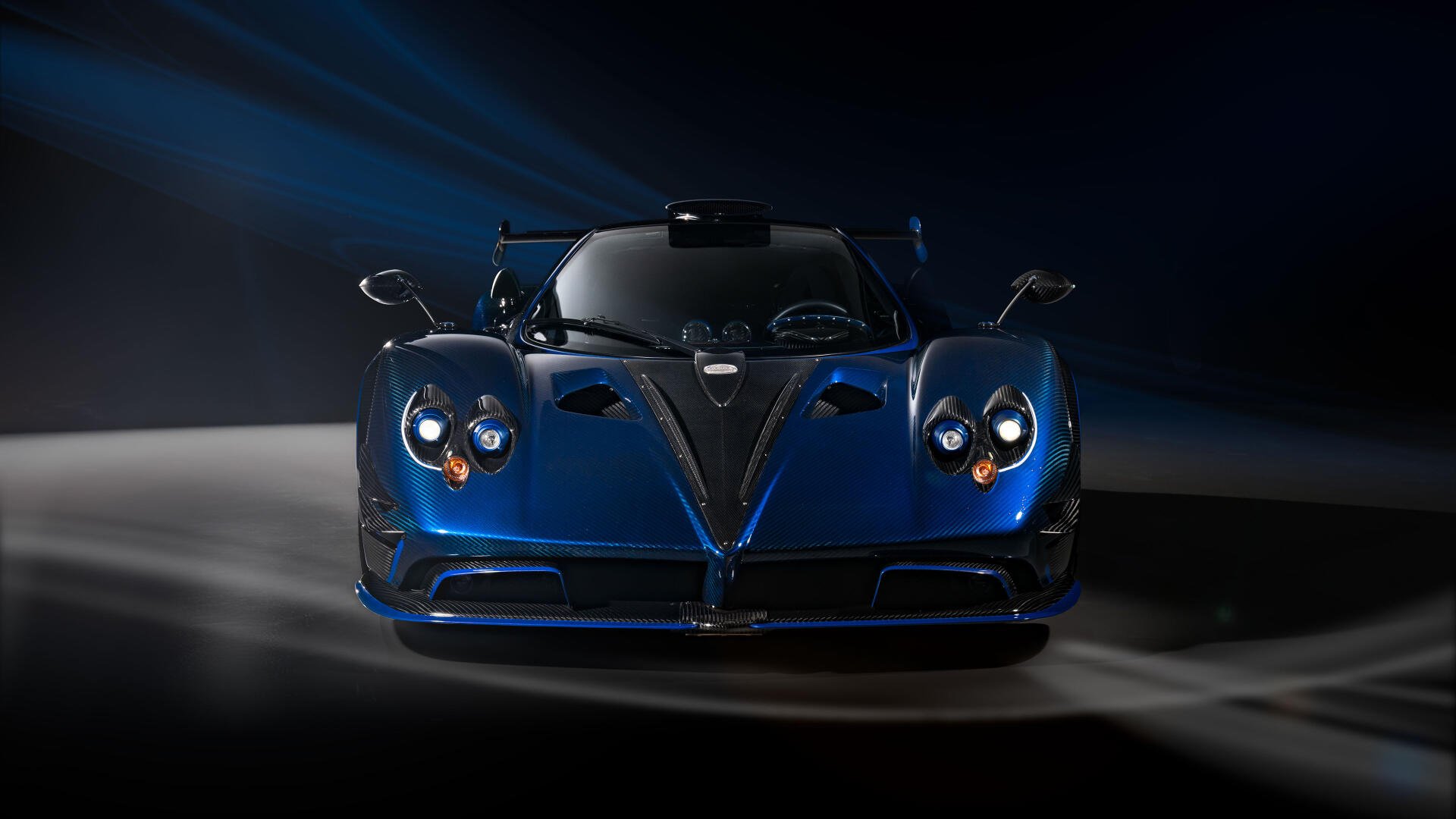 Blue Pagani Zonda racing car, front view on a dark, dramatic backdrop — 4K Ultra HD PC desktop wallpaper/background.
