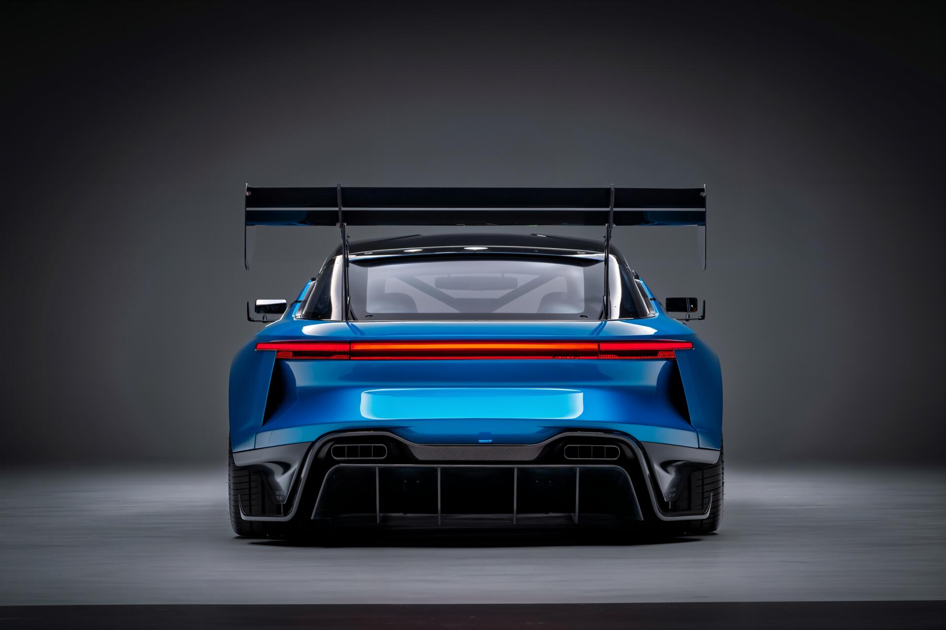 Rear view of a blue Jensen Interceptor GTX sports car with an oversized spoiler (Spoiler, DC Comics), rendered as a 4K Ultra HD PC desktop wallpaper.