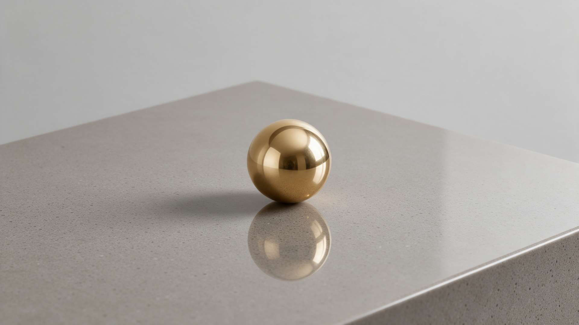 Clean 2K Quad HD PC desktop wallpaper: a reflective gold sphere on a smooth gray surface casting a crisp reflection.