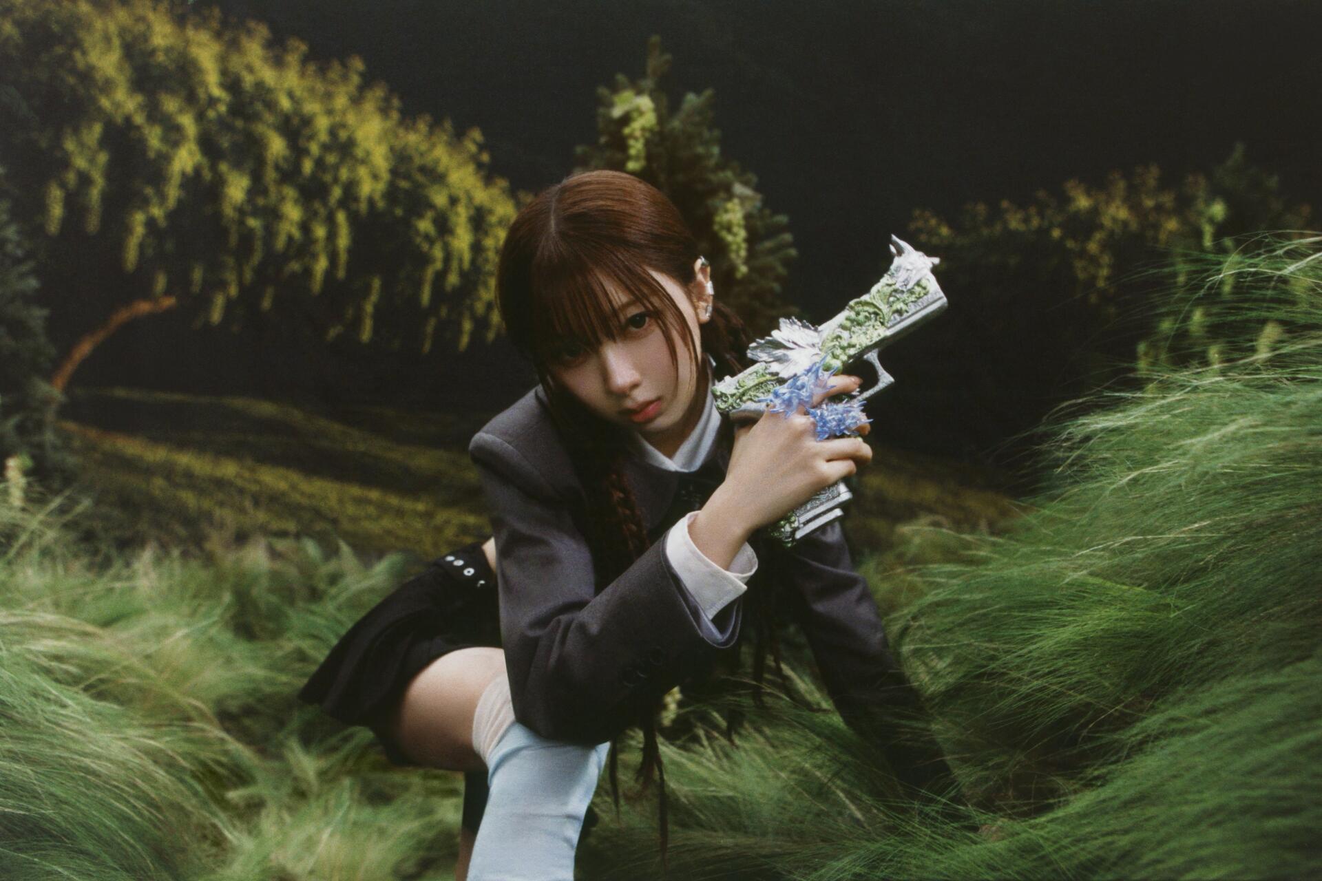 Portrait of a woman in a moody Sour Grapes scene, holding a floral-decorated prop amid swaying grass — 4K Ultra HD PC desktop wallpaper.