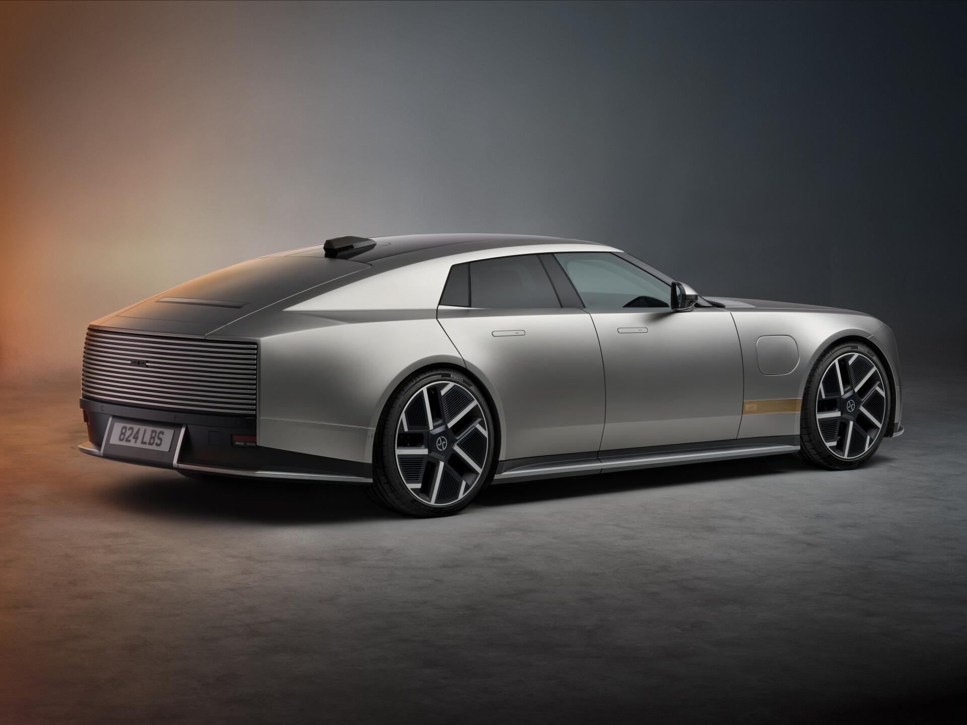Silver Jaguar Type 01 luxury concept car in a dramatic studio, shown in 8K Ultra HD desktop wallpaper.