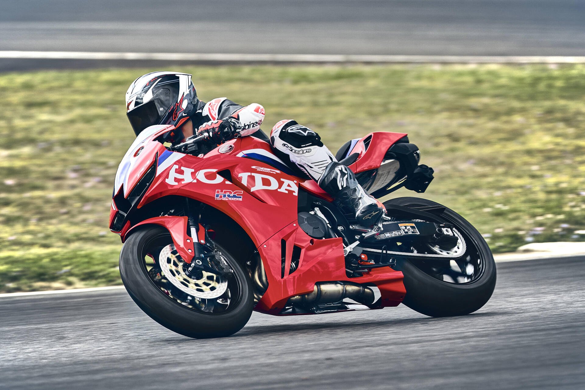 Honda CBR600RR racing motorcycle leaning through a track corner, featured in a 4K Ultra HD PC desktop wallpaper.