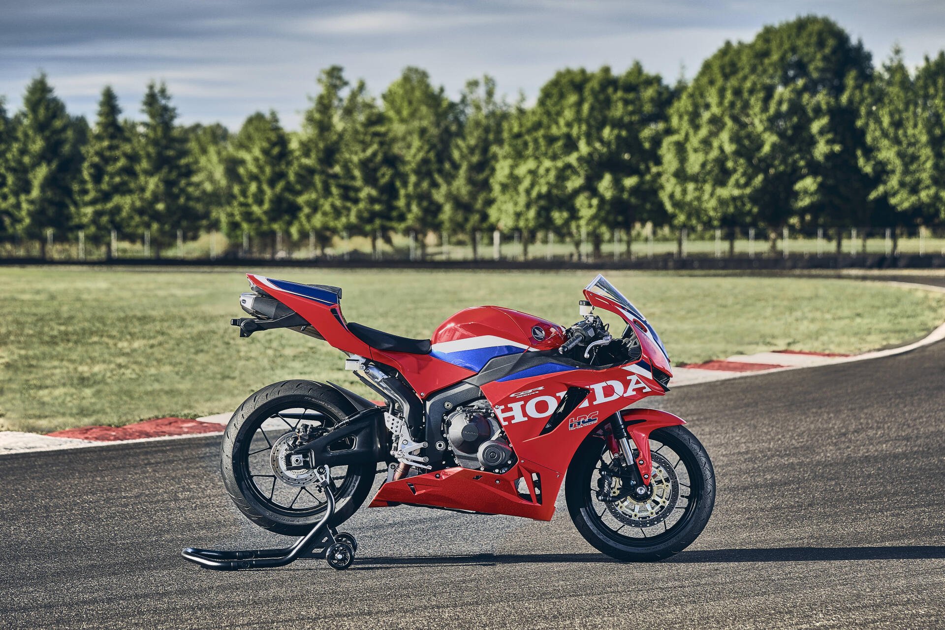 Red Honda CBR600RR sportbike on a racetrack, featured in a 4K Ultra HD PC desktop wallpaper and background.