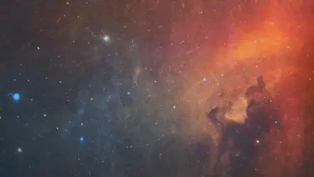 4K Ultra HD PC desktop wallpaper and background featuring cosmic dust: swirling blue and orange nebula clouds and scattered stars across a deep-space vista.