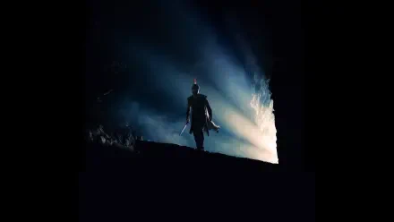 Silhouetted warrior on a dark ridge, backlit by dramatic blue-white light — The Odyssey (2026) 4K Ultra HD PC desktop wallpaper and background.