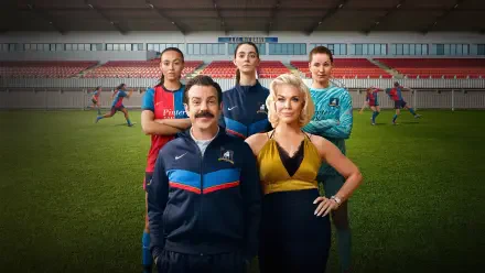 4K Ultra HD PC desktop wallpaper featuring a mustachioed soccer coach with three players on a stadium pitch; image tagged Ted Lasso.