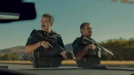 Two armed officers stand alert in a sunlit roadside standoff, cinematic tension — 4K Ultra HD PC desktop wallpaper background.