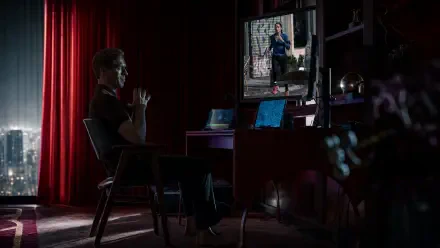4K Ultra HD PC desktop wallpaper: a man at a computer in a dim study watches a poster of an actress from The Runner.