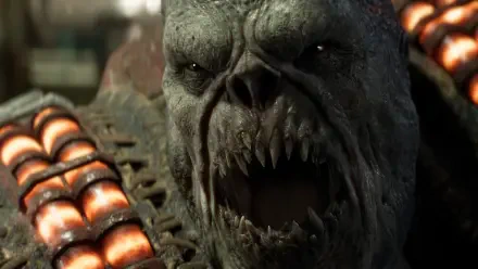 Gears of War: E-Day 2K Quad HD PC wallpaper — close-up of a snarling Gears of War alien/monster with jagged teeth and glowing armored ammo tubes.