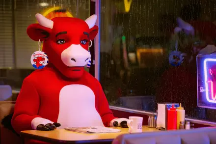 4K Ultra HD PC desktop wallpaper: The Not Laughing Cow meme — a red cow costume character sits at a diner counter, expressionless, with a mug and neon sign in the background.