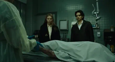 The Exorcist: Martyrs 2K Quad HD desktop wallpaper featuring Scarlett Johansson beside a covered corpse in a dim hospital morgue.