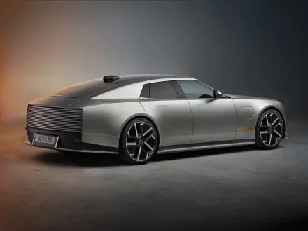Silver Jaguar Type 01 luxury concept car in a dramatic studio, shown in 8K Ultra HD desktop wallpaper.