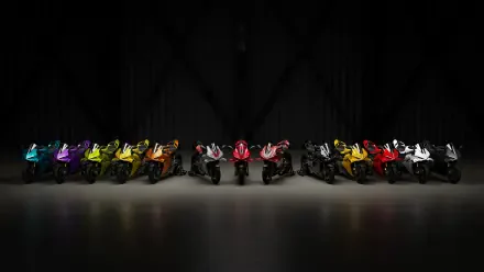 4K Ultra HD desktop wallpaper featuring a colorful lineup of Ducati Panigale V4 sport bikes against a black background.