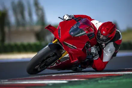 Ducati Panigale V4 and motorcyclist leaning into a racetrack turn, 8K Ultra HD desktop wallpaper background.