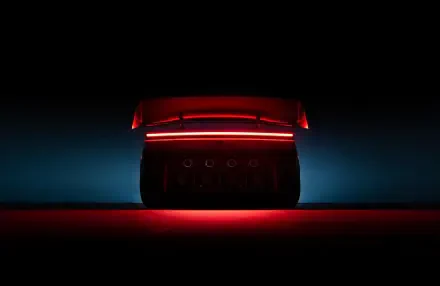 Tesla Roadster rear taillight glowing red in a dark scene, 2K Quad HD PC desktop wallpaper