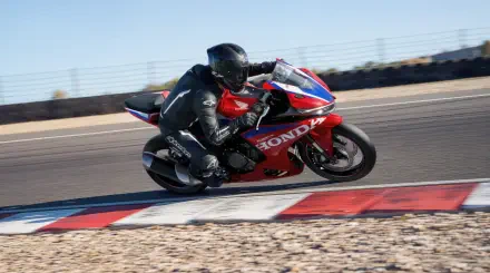 Honda CBR500R Four racing motorcycle on a track, featured in a 5K Ultra HD PC desktop wallpaper and background.