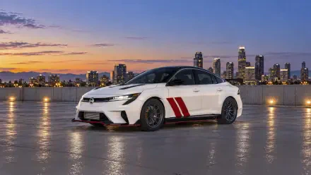 White Nissan Sentra Spec V Concept sedan by a city waterfront at sunset, 2K Quad HD PC desktop wallpaper and background.