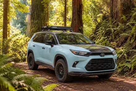 Toyota Grand Highlander Woodland Concept SUV on a forest trail, featured in a 2K Quad HD PC desktop wallpaper background.
