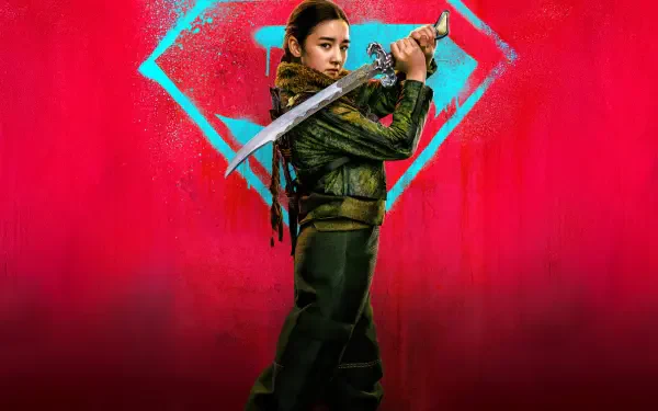 Supergirl (2026) 5K Ultra HD PC desktop wallpaper: a green‑suited Supergirl grips a sword before a glowing cyan S emblem set against a vivid red background.