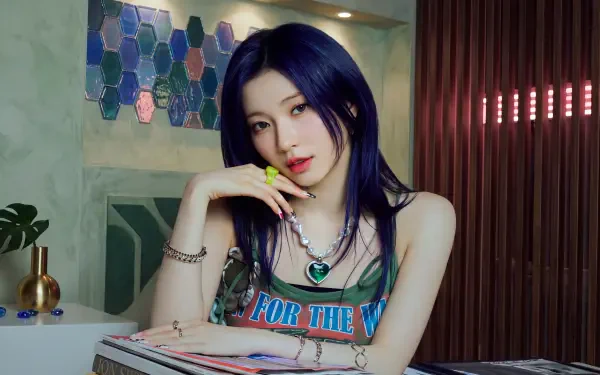 Blue-haired young woman with k-pop–inspired Japanese model styling, layered necklaces and bright nails, seated in a chic interior — 5K UHD wallpaper.