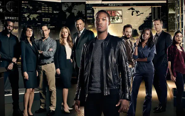 2K Quad HD PC desktop wallpaper for 24: Legacy showing a diverse ensemble of agents in a dim command-center, with a leather-jacketed lead figure standing front and center.