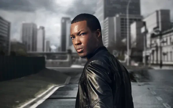 24: Legacy — 4K Ultra HD PC desktop wallpaper: a person in a leather jacket glances over their shoulder on a moody urban street with a towering skyline.