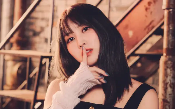 5K desktop wallpaper of a Japanese k-pop idol–style model posing finger-to-lips on an industrial staircase, warm soft lighting.