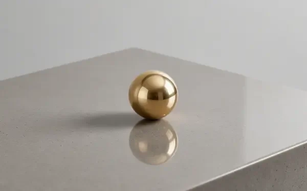 Clean 2K Quad HD PC desktop wallpaper: a reflective gold sphere on a smooth gray surface casting a crisp reflection.