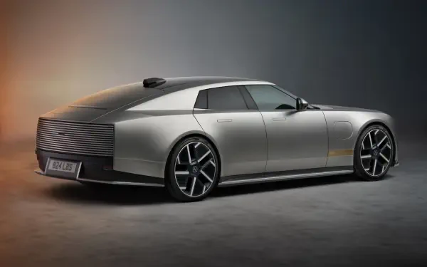 Silver Jaguar Type 01 luxury concept car in a dramatic studio, shown in 8K Ultra HD desktop wallpaper.