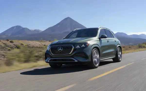 Mercedes-Benz GLS SUV driving along a mountain road in a 4K Ultra HD PC desktop wallpaper background.