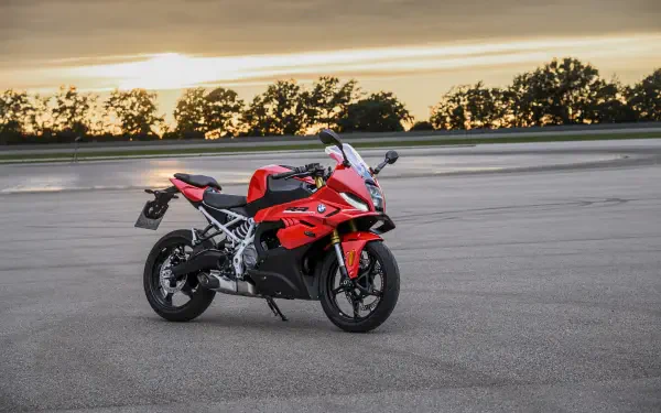 Red BMW F 450 RR sport bike on a paved track at sunset, featured in an 8K Ultra HD desktop wallpaper.