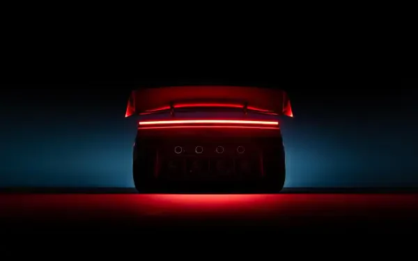 Tesla Roadster rear taillight glowing red in a dark scene, 2K Quad HD PC desktop wallpaper